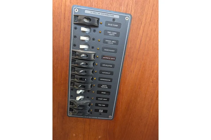 Slide: The Image of Control panel of a 2008 Ranger 2510 Bay Ranger boat with labeled switches. - 32