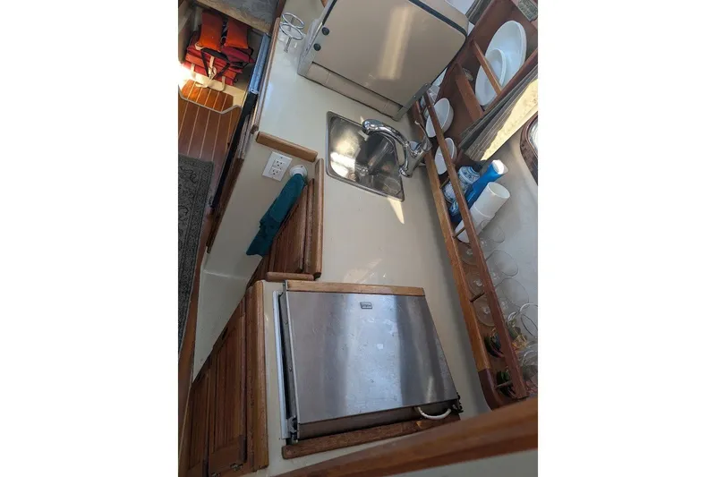 Slide: The Image of 2008 Ranger 2510 Bay Ranger boat interior with sink, fridge, and storage. - 34