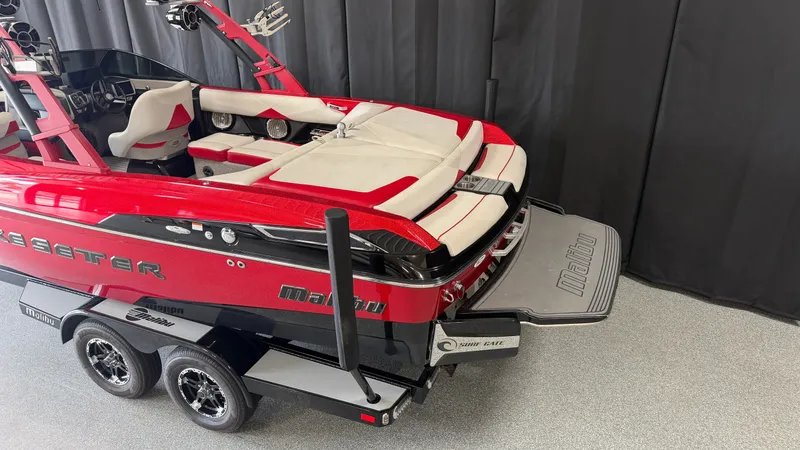 Slide: The Image of A red 2015 Malibu Wakesetter 23 LSV boat with sleek design and dual axle trailer. - 6