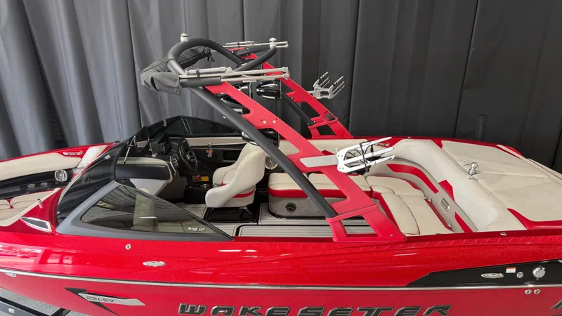 Slide: The Image of A red 2015 Malibu Wakesetter 23 LSV boat with white seating and a black wakeboard tower. - 5