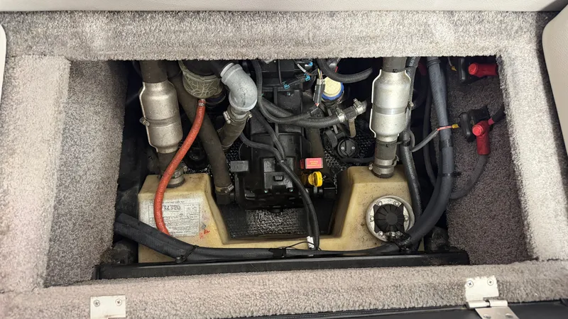 Slide: The Image of A view of the engine compartment of a 2015 Malibu Wakesetter 23 LSV with visible hoses and fittings. - 42