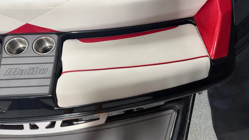 Slide: The Image of Close-up of a Malibu Wakesetter 23 LSV seating area with cup holders and red accents. - 16