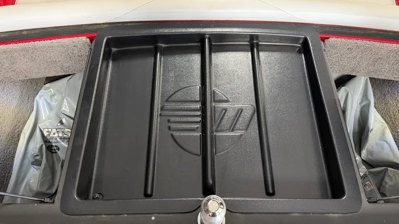 Slide: The Image of The image shows the storage compartment of a 2015 Malibu Wakesetter 23 LSV. - 24