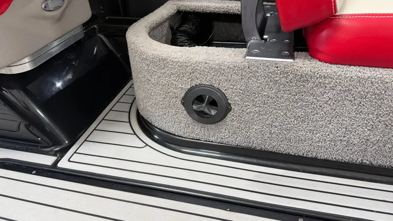Slide: The Image of Close-up of a boat interior with carpeted flooring and red seats. - 30