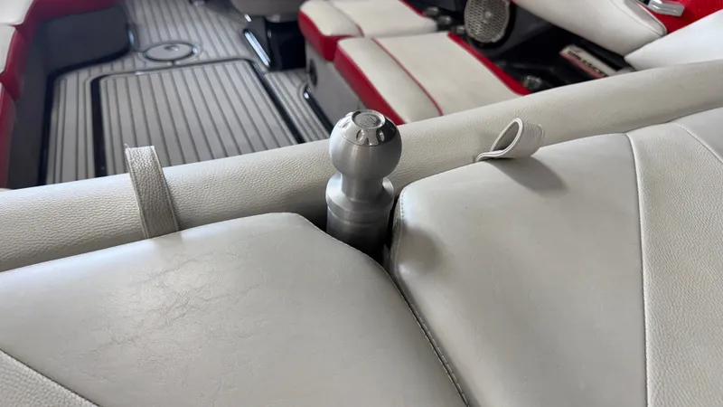 Slide: The Image of Close-up of a gray and red boat seat with a metal knob. - 19