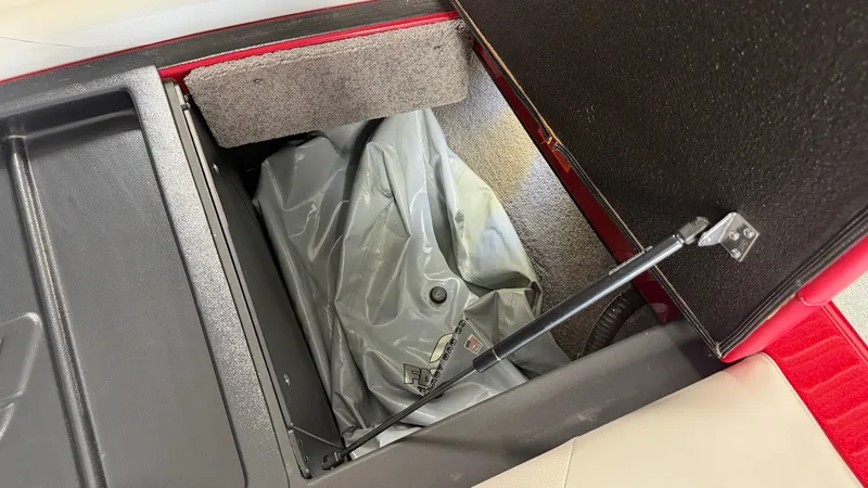 Slide: The Image of An open storage compartment in the boat reveals a gray inflatable item. - 21
