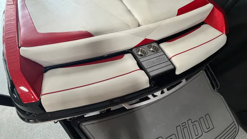 Slide: The Image of Rear view of a Malibu Wakesetter 23 LSV with red and white upholstery and cup holders. - 12