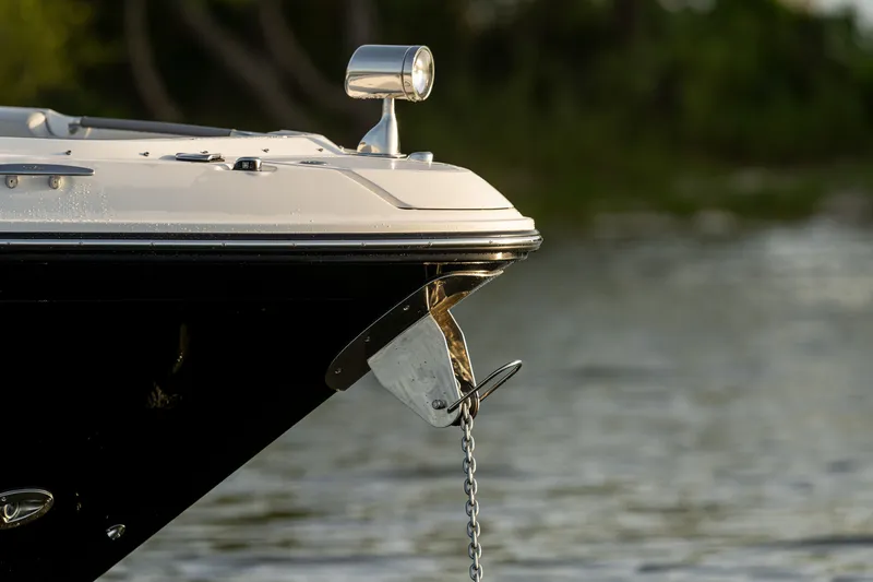 Slide: The Image of Close-up of a 2027 Sea Ray SLX 400 anchor hanging over the water. - 36