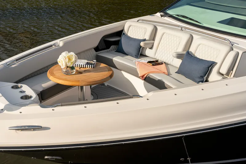 Slide: The Image of The image shows the bow of a 2027 Sea Ray SLX 400 with elegant seating and a wooden table. - 34