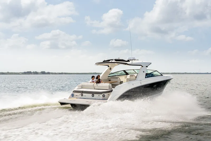 Slide: The Image of A 2027 Sea Ray SLX 400 speeds across the water, with people on board. - 2