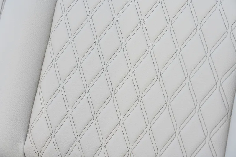 Slide: The Image of Close-up of white quilted upholstery with a diamond pattern. - 39