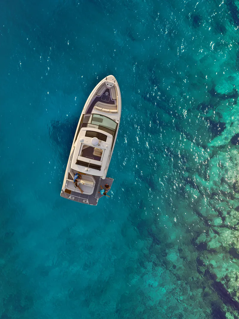 Slide: The Image of Aerial view of a 2027 Sea Ray SLX 400 on clear, turquoise water. - 37