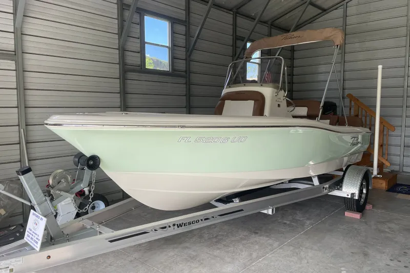 The Image of 2024 Pioneer 180 Islander boat on trailer in a garage setting. - 0