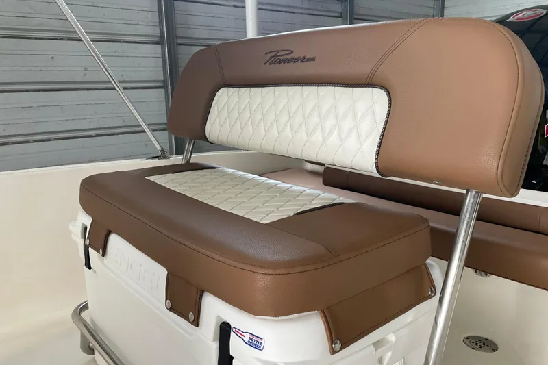 Slide: The Image of 2024 Pioneer 180 Islander boat seat with brown and white cushioned design. - 8