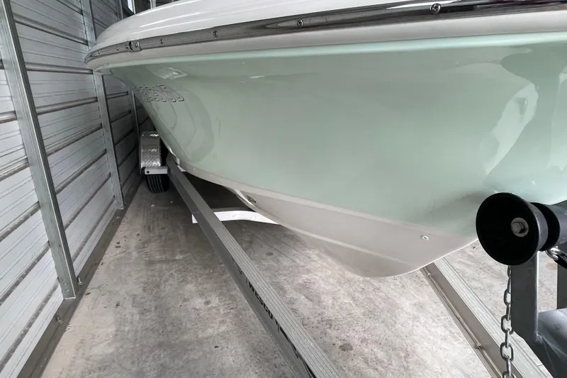 Slide: The Image of 2024 Pioneer 180 Islander boat on trailer in storage facility. - 2