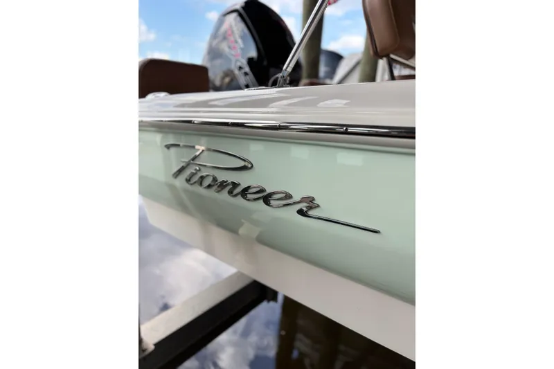 Slide: The Image of 2024 Pioneer 180 Islander boat with sleek design and chrome logo detail. - 3