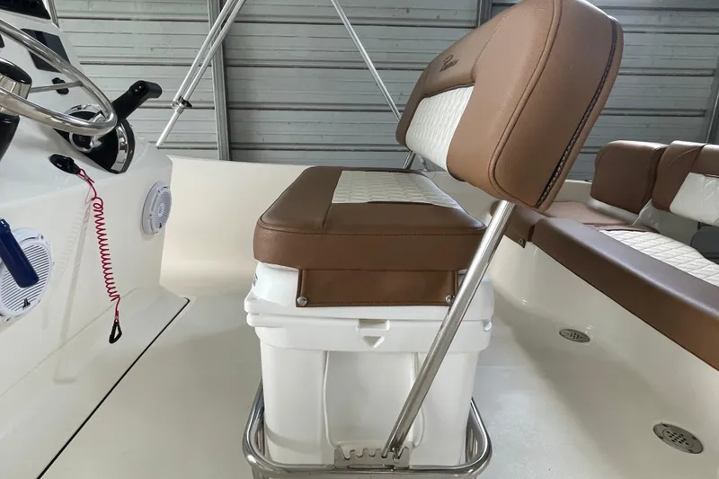 Slide: The Image of 2024 Pioneer 180 Islander boat interior with cushioned seating and steering wheel. - 10