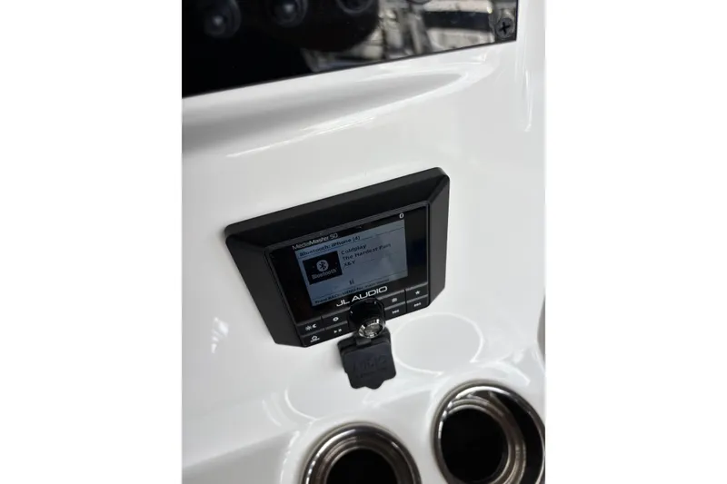 Slide: The Image of 2024 Pioneer 180 Islander boat dashboard with JL Audio system and cup holders. - 22