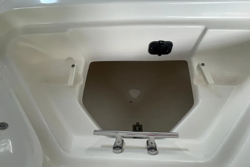 Slide: The Image of Storage compartment of 2024 Pioneer 180 Islander boat, featuring a sleek white interior. - 15
