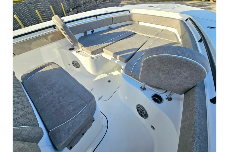 Slide: The Image of 2026 Sea Hunt Ultra 285 SE boat interior with cushioned seating and speakers. - 21