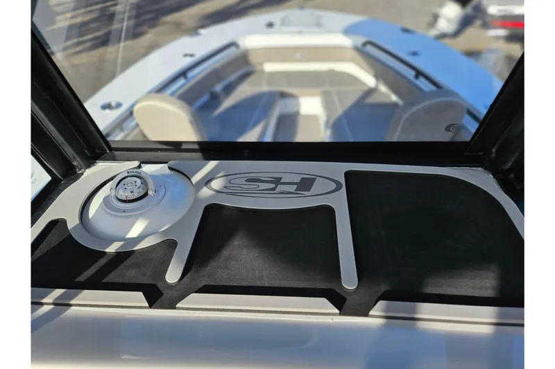 Slide: The Image of 2026 Sea Hunt Ultra 285 SE boat interior with compass and logo detail. - 16