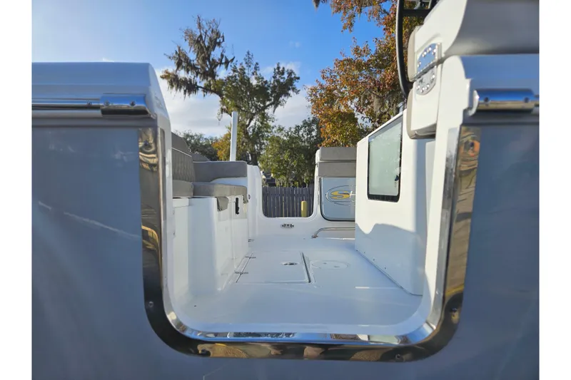 Slide: The Image of 2026 Sea Hunt Ultra 285 SE boat interior with seating and open deck. - 6