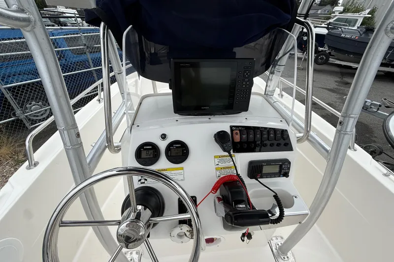 Slide: The Image of 2015 Edgewater 170CC boat console with steering wheel, gauges, and navigation equipment. - 9