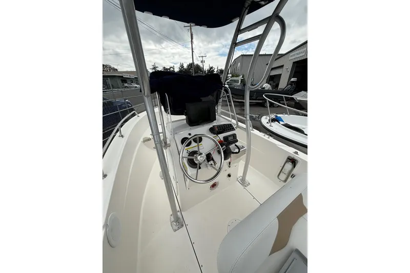 Slide: The Image of 2015 Edgewater 170CC boat interior with steering wheel and navigation equipment. - 8
