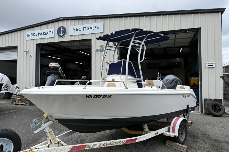 The Image of 2015 Edgewater 170CC boat on trailer outside yacht sales building. - 0