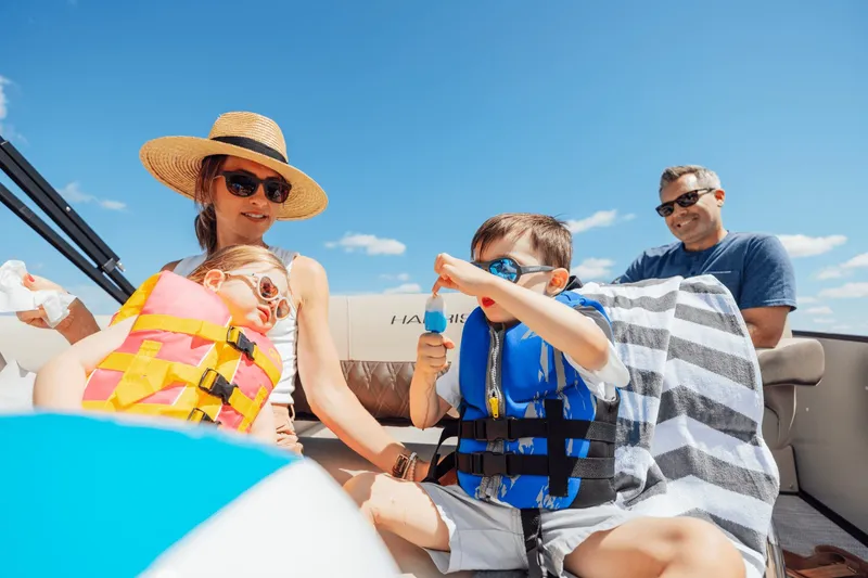 Slide: The Image of Family enjoying a boat ride on a Harris 210SL, children wearing life jackets. - 9