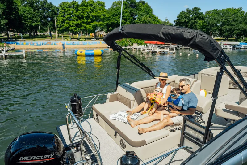 Slide: The Image of Family enjoying a boat ride on a 2027 Harris 210SL. - 12