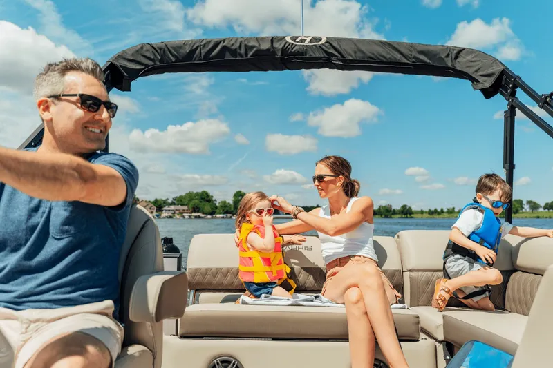 Slide: The Image of Family enjoying a boat ride on a 2027 Harris 210SL. - 23