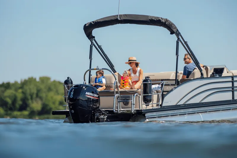 Slide: The Image of A family enjoys a boat ride on a Harris 210SL pontoon boat. - 38