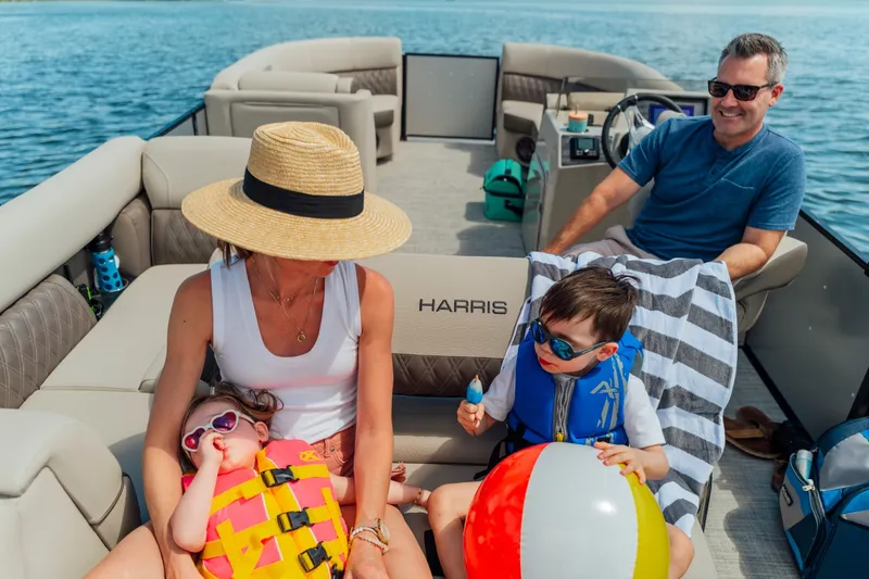 Slide: The Image of A family enjoys a boat ride on a Harris 210SL. Children wear life jackets and play with a ball. - 10