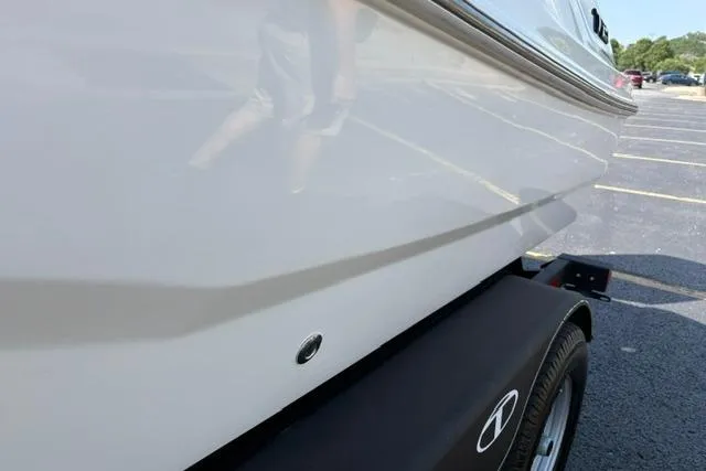 Slide: The Image of 2024 Tahoe T21 boat on trailer, side view in parking lot. - 26