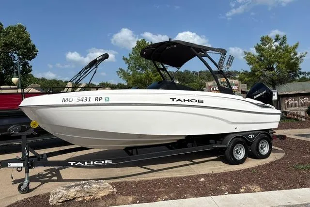 Slide: The Image of 2024 Tahoe T21 boat on trailer, parked outdoors under clear sky. - 3