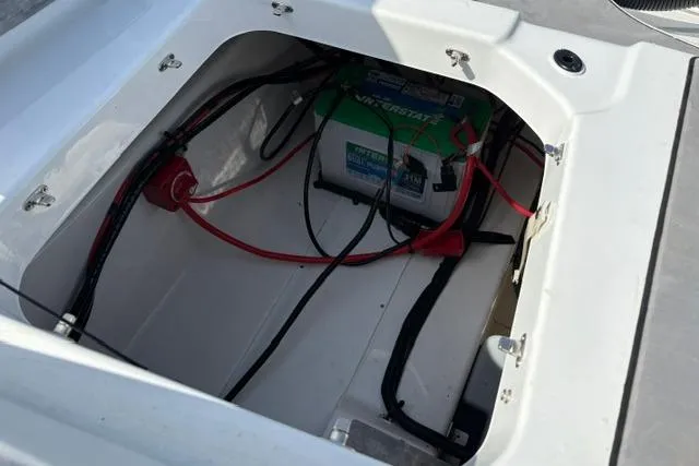 Slide: The Image of 2024 Tahoe T21 boat battery compartment with wiring and connections. - 29