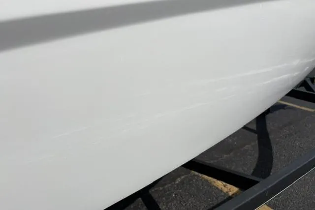 Slide: The Image of 2024 Tahoe T21 boat hull on trailer, showcasing sleek white design. - 33
