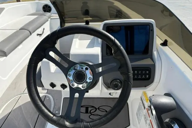 Slide: The Image of 2024 Tahoe T21 boat dashboard with steering wheel and control panel. - 17