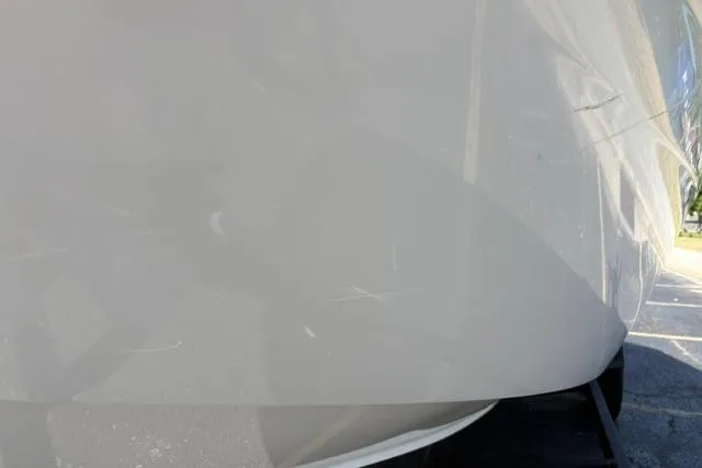 Slide: The Image of 2024 Tahoe T21 boat hull with visible scratches in sunlight. - 23