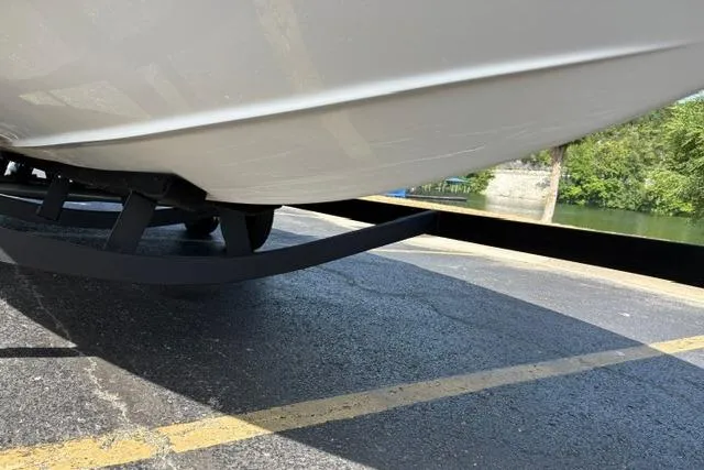 Slide: The Image of 2024 Tahoe T21 boat on trailer, parked on asphalt near water. - 37