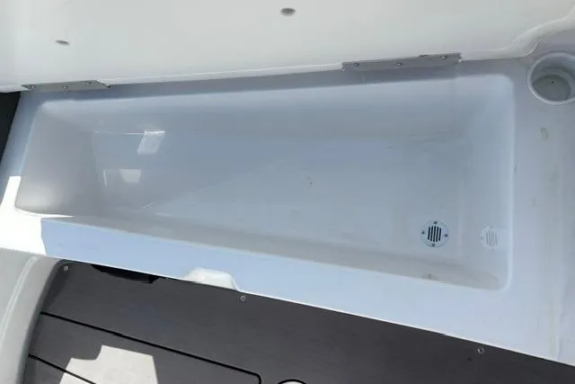Slide: The Image of 2024 Tahoe T21 boat storage compartment with drainage system, featuring sleek white interior design. - 35