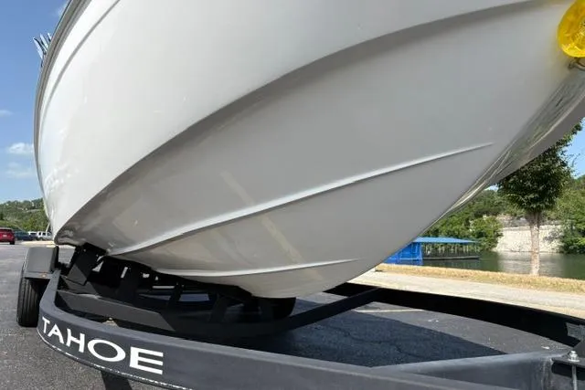 Slide: The Image of 2024 Tahoe T21 boat on trailer, showcasing sleek hull design and branding. - 36