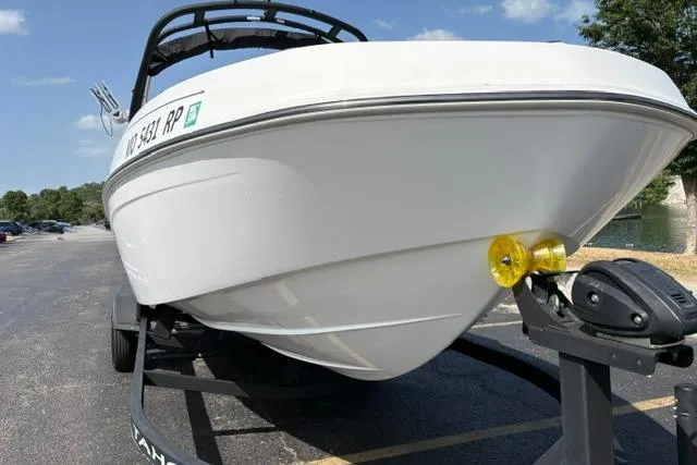 Slide: The Image of 2024 Tahoe T21 boat on trailer in parking lot, sunny day. - 6