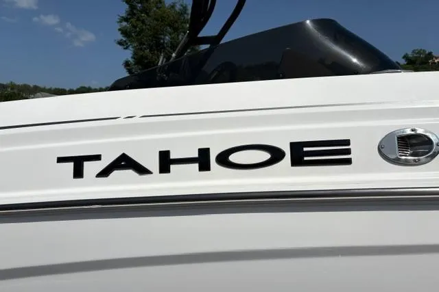 Slide: The Image of 2024 Tahoe T21 boat, sleek white exterior with bold black lettering. - 19