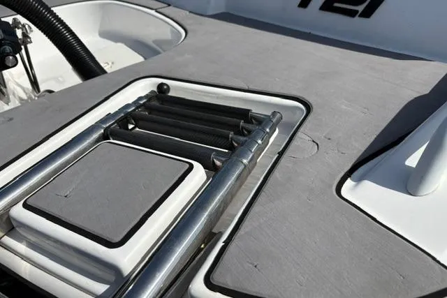 Slide: The Image of 2024 Tahoe T21 boat with a sleek, integrated swim ladder on the deck. - 31