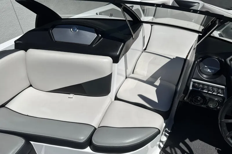 Slide: The Image of 2015 Axis A20 boat interior with white and black seating, dashboard, and controls. - 14