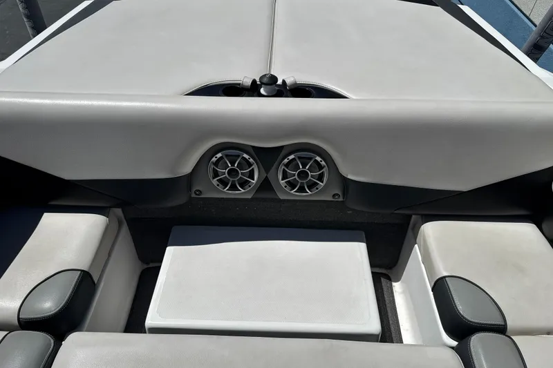 Slide: The Image of Interior of a 2015 Axis A20 boat featuring seating and built-in speakers. - 24