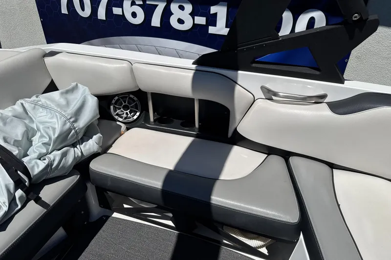 Slide: The Image of Interior of a 2015 Axis A20 boat with gray seating and speaker. - 18