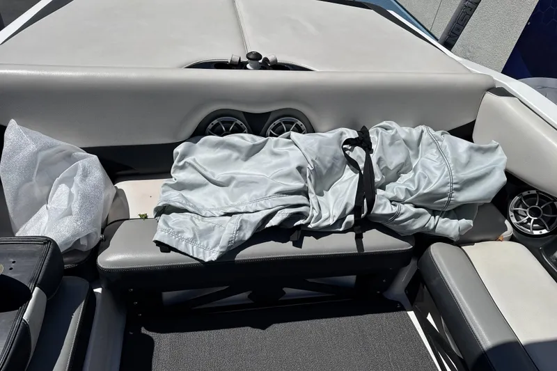 Slide: The Image of 2015 Axis A20 boat interior with folded cover and speakers on seats. - 17